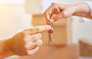 Keys Being Transferred For Buying First Home