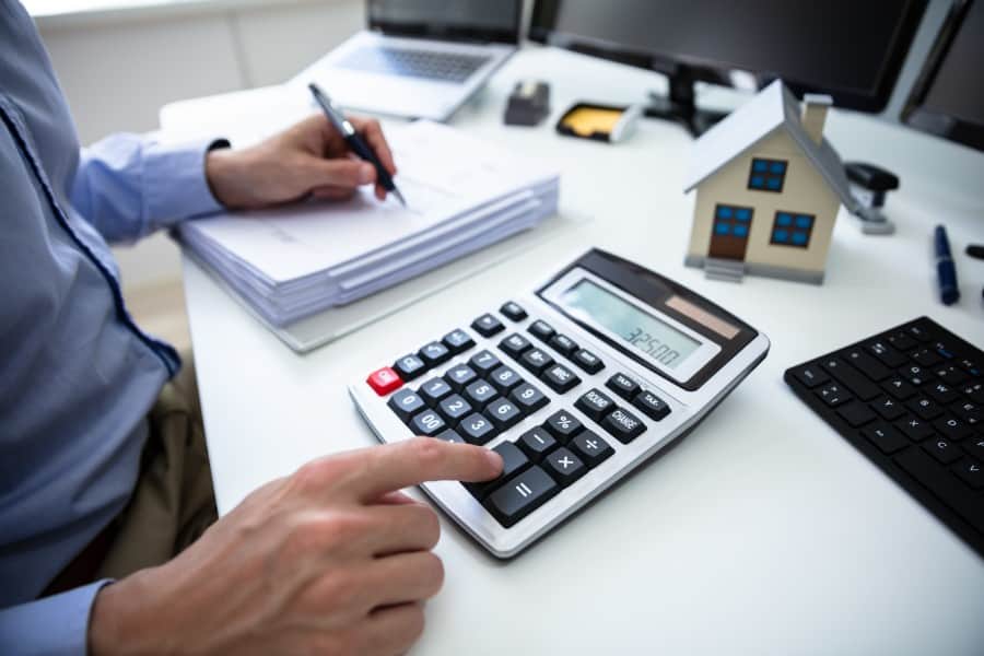 Property investor calculating rental yield - Assets For Life