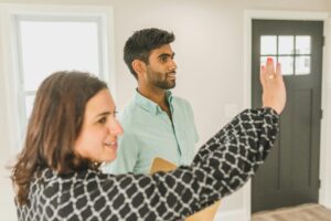 Estate agent showing vacant property to a potential buyer