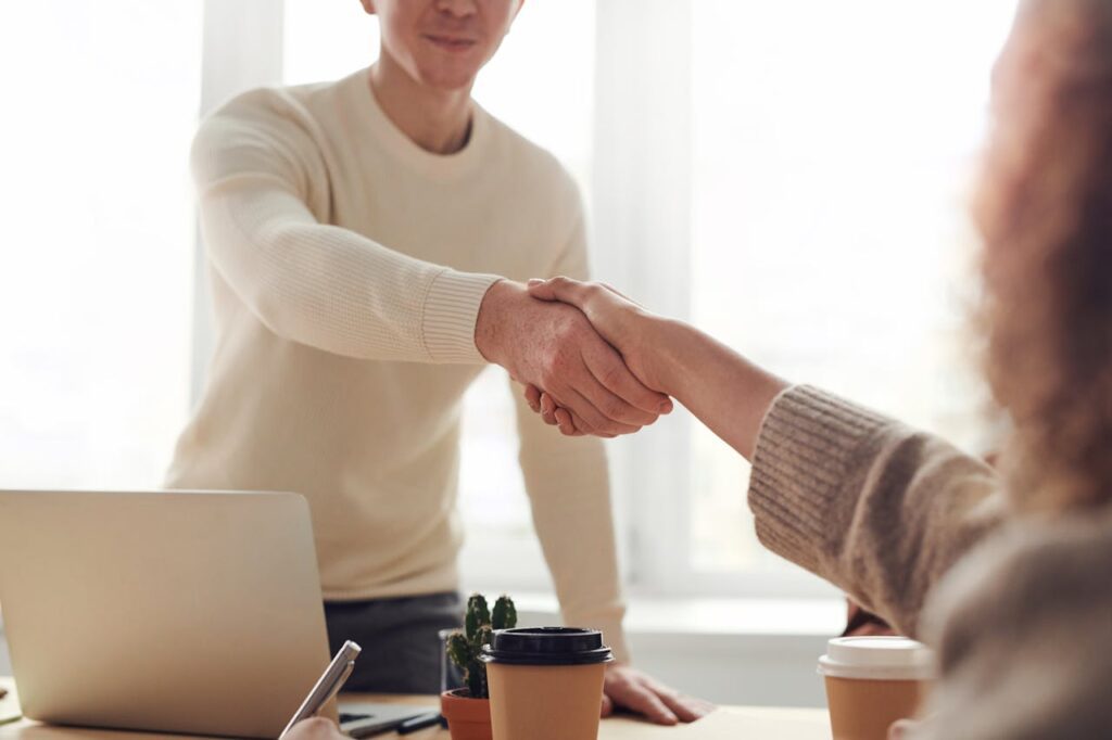 Potential let agreed tenant shaking hands with a landlord - Assets For Life