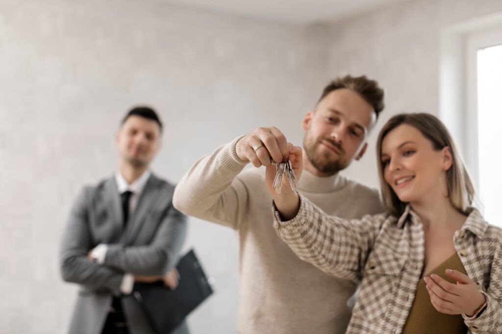 A couple holding the keys to a property for subletting - Assets For Life