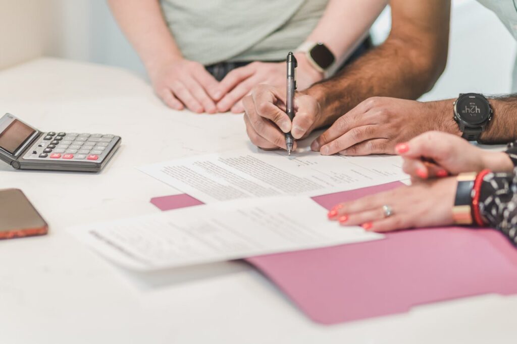 People reviewing a bridging loan document - Assets For Life