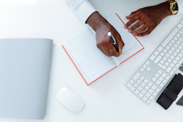 Person writing on a blank piece of paper - Assets For Life