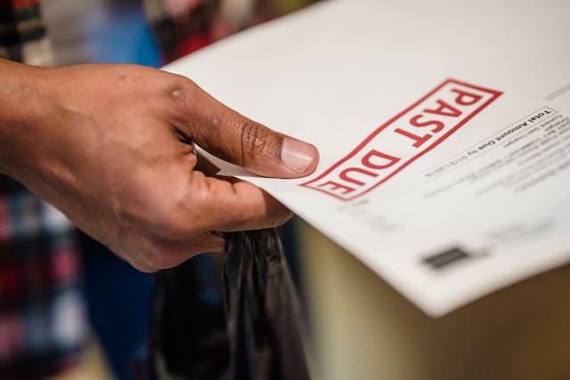 Person holding rent arrears document - Assets For Life