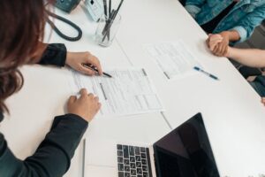 Couple signing a property lease document - Assets For Life