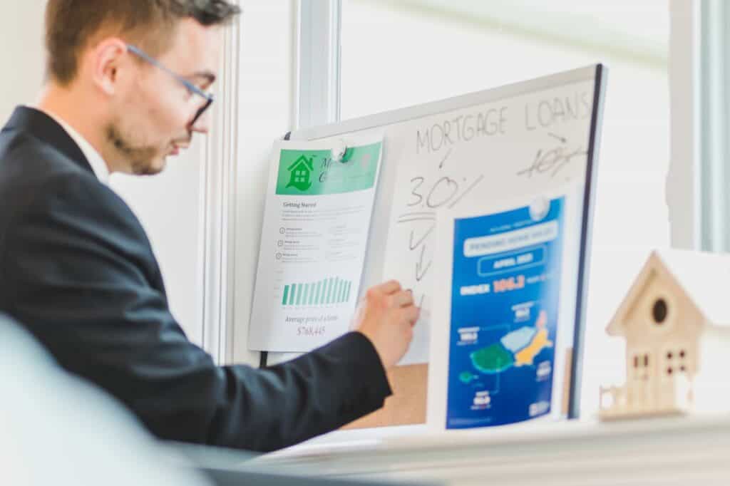Man working out ROI on a property deal - Assets For Life