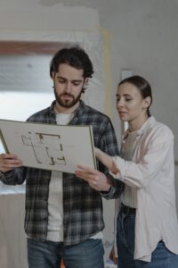 Newbie property investors looking at floor plans - Assets For Life