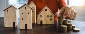 Investment money next to property figures - Assets For Life