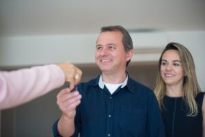 Couple receiving keys to rental property - Assets For Life